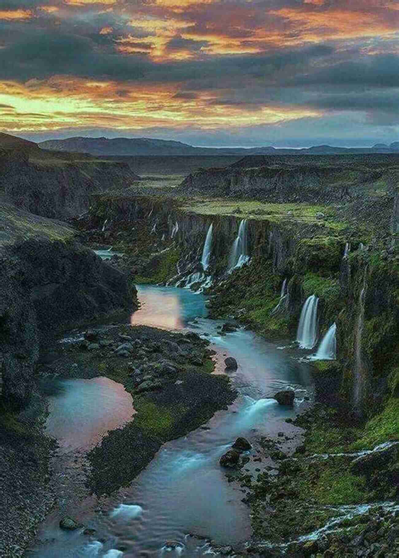 A Breathtaking Landscape Painted By Scenery Jane Lordson A River Flowing Through Lush Green Fields With Colorful Wildflowers Blooming On The Banks Scenery Jane Lordson