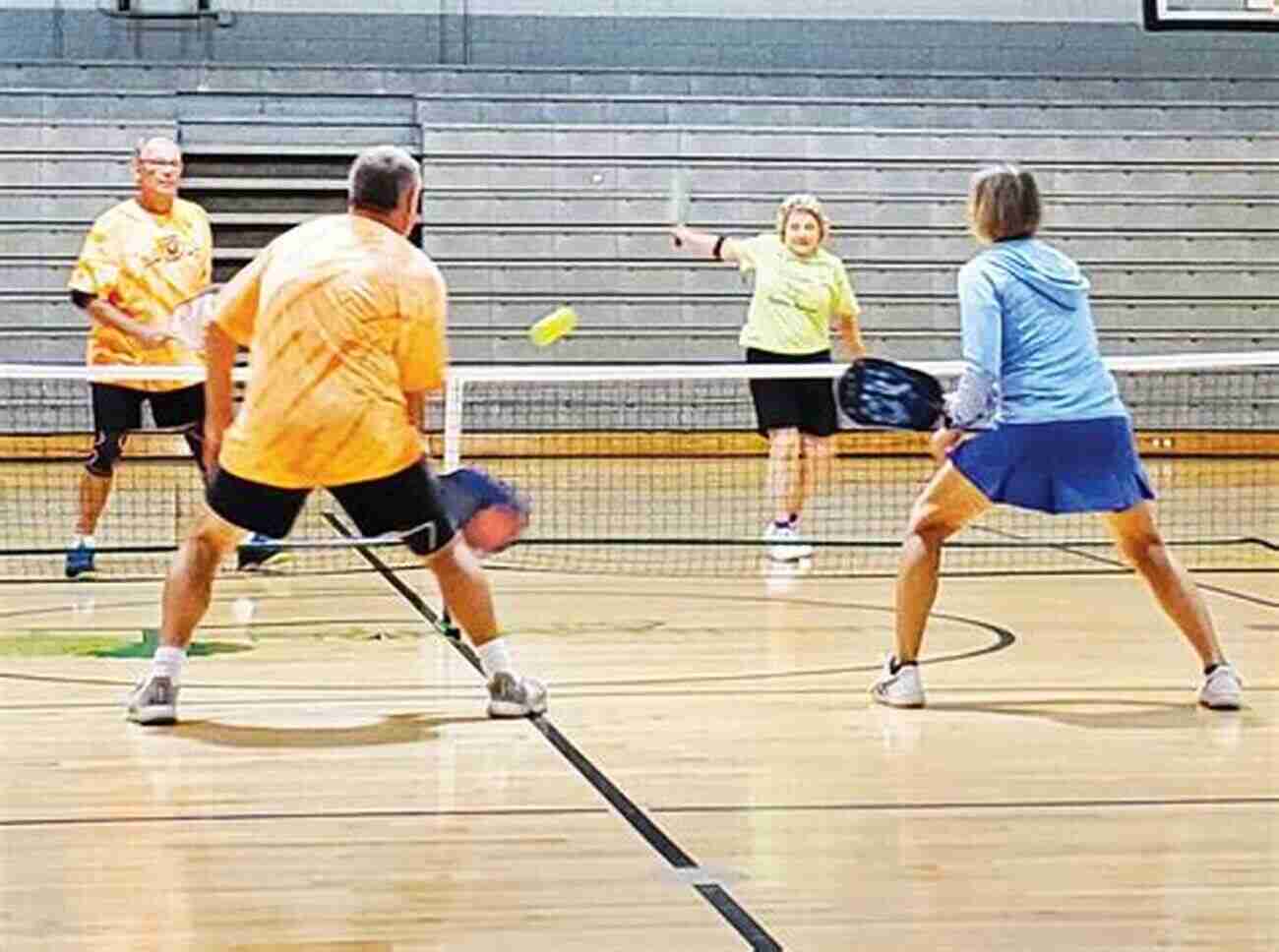 A Group Of People Playing Pickleball THE ULTIMATE GUIDE TO PICKLE BALL FOR BEGINNERS: BASIC TIPS AND RULES OF PICKLE BALL ALL YOU NEED TO KNOW